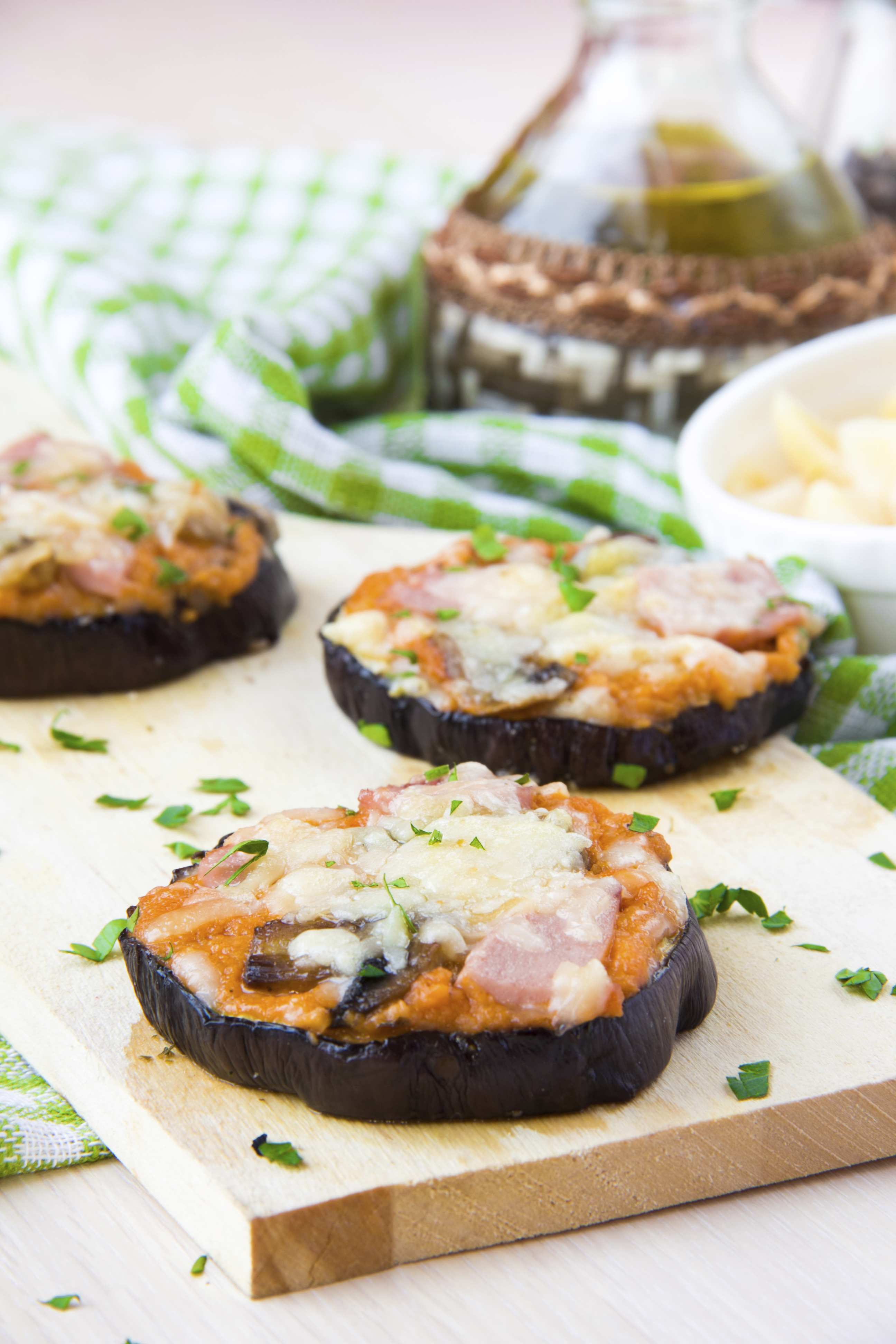 Slice of fried aubergines with tomato sauce, mushrooms, ham and